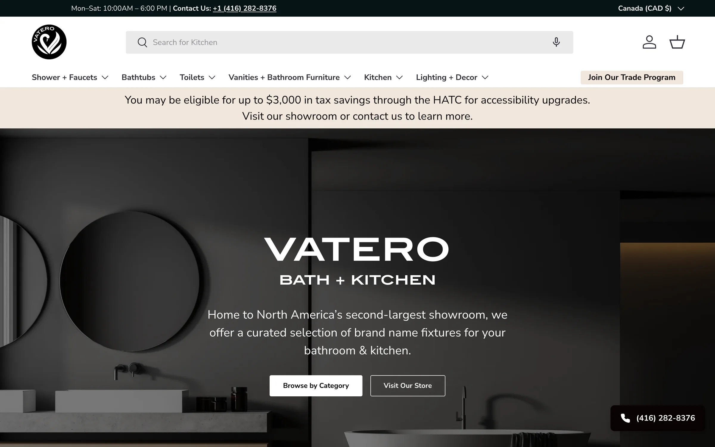 Vatero Bath and Kitchen homepage showing a dark modern bathroom interior with a round mirror and freestanding basin